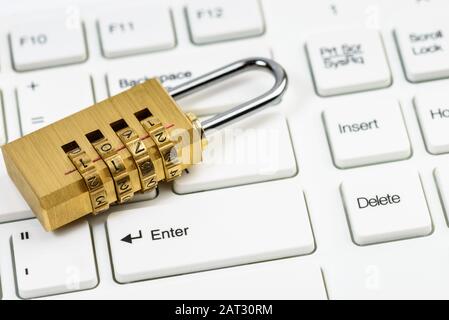 Computer security concept with combination lock padlock on white keyboard Stock Photo