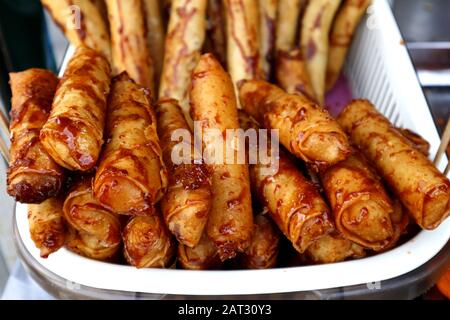 Photo of a bunch of freshly cooked Turon or deep fried saba banana in spring roll wrapper with brown sugar Stock Photo
