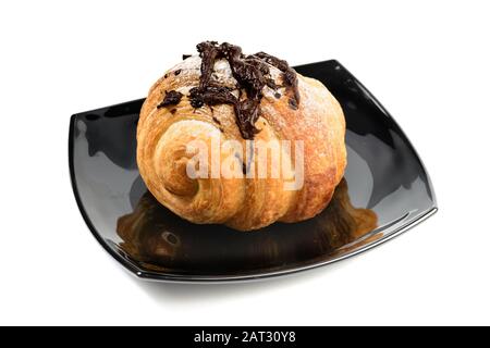 French croissant with chocolate on black plate isolated on white background Stock Photo