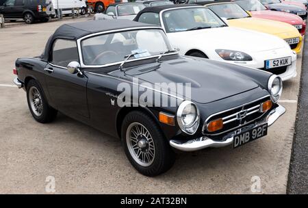 Three-quarters front view of a Black, 1968, Honda S800, on