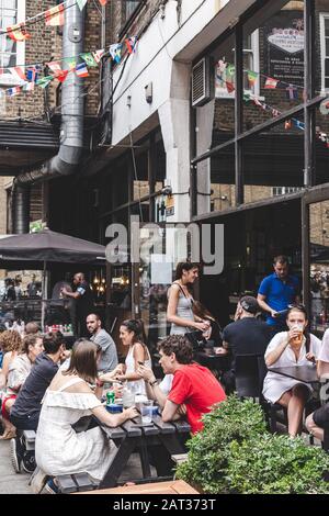 Young People resting in Dray Walk outside Sunday Up Market, Old Truman ...