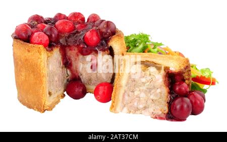 Pork pie topped with cranberries with fresh salad isolated on a white background Stock Photo