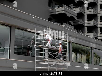 Male workfore working on a new hotel at Playa de Maspalomas, Gran Canaria. Stock Photo