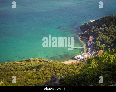 Top view shot of a small harbor next to a forest in Portinho da Arrabida, Setúbal, Portugal Stock Photo