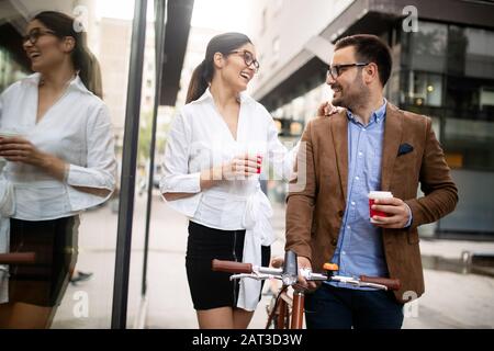 Business people discussing and smiling while walking together outdoor Stock Photo