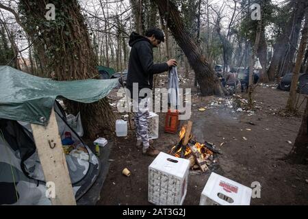Migrants sleeping rough in the Calais illegal refugee camps on the outskirts of the Calais port seeking to cross the channel to the UK Stock Photo