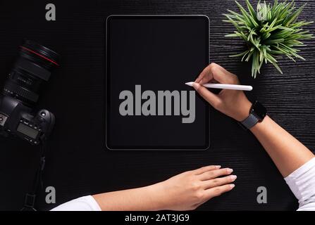 designer using stylus pen on top view Stock Photo