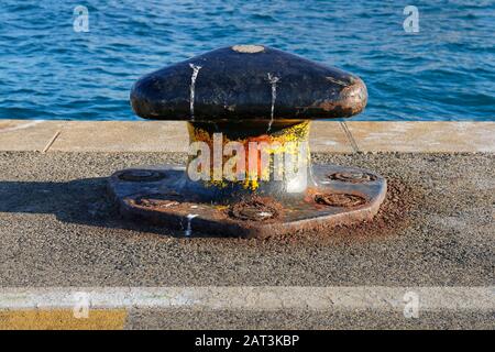 Rusty mooring bollard on a pier in Split harbor in Croatia Stock Photo