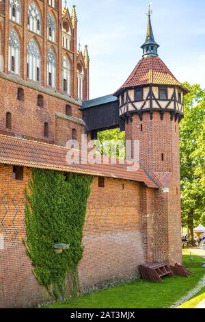 Malbork, Pomerania / Poland - 2019/08/24: Medieval Teutonic Order Castle in Malbork, Poland - Middle Castle fortress surrounded with the inner defense walls and a moat Stock Photo