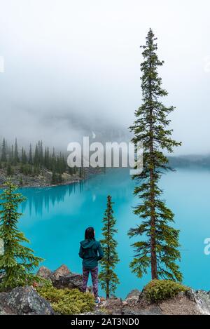 Enjoying the breath taking scenery of Moraine Lake early morning in Banff National Park Stock Photo