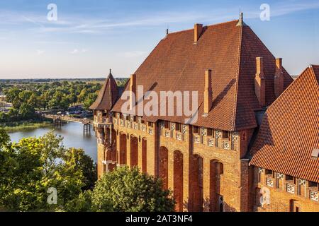 Malbork, Pomerania / Poland - 2019/08/24: Aerial panoramic view of the monumental gothic Grand Masters�â�� Palace in the High Castle part of the medieval Teutonic Order Castle by the Nogat river in Malbork, Poland Stock Photo