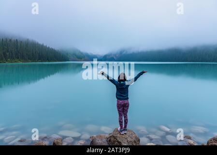 Woman enjoying the view of Lake Louise Stock Photo