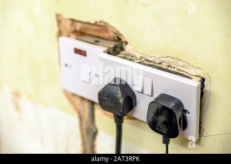 electric socket in a wall during renovation in england uk. Stock Photo