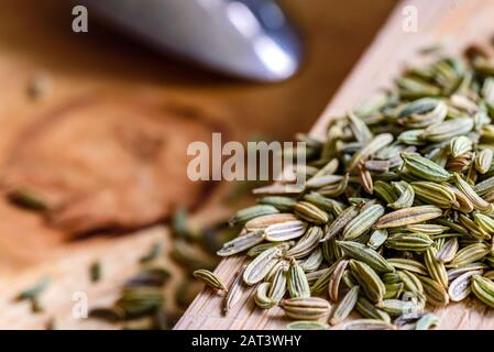 fennel seeds loose on wooden board ready to be brewed as tea. Stock Photo