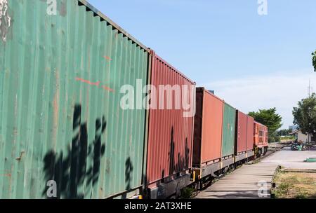 The diesel-electric locomotive is running with the container boxcar to the urban station,Bangkok Thailand. Stock Photo