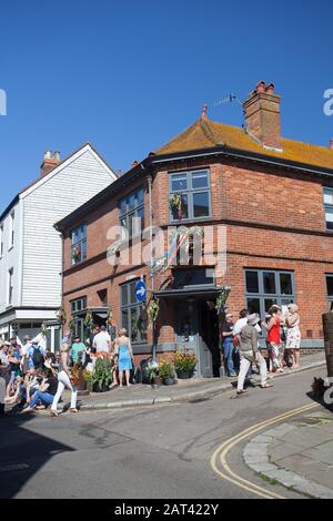 People outside the Crown pub on All Saint StreetHastings during Jack in the Green May Bank Holiday weekend, Hastings, East Sussex, UK Stock Photo