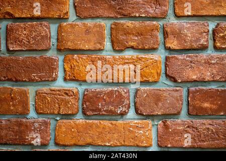 Weathered stained old brick wall background Stock Photo