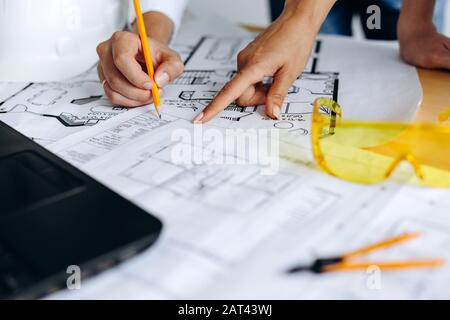 Hands of architects working on blueprints in the office Stock Photo