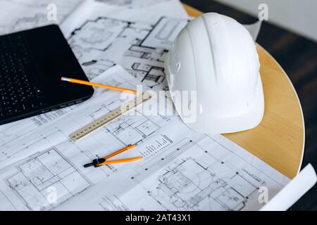 Engineering tools on wooden table with drawings Stock Photo