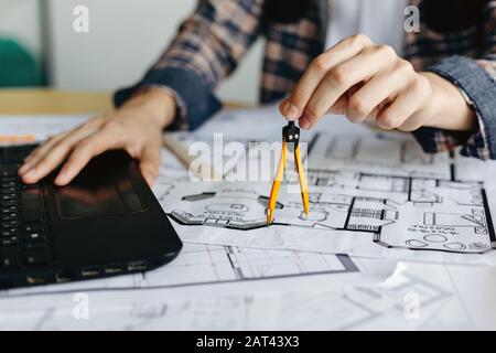 Civil engineer drawing with compass when working on building plan Stock ...