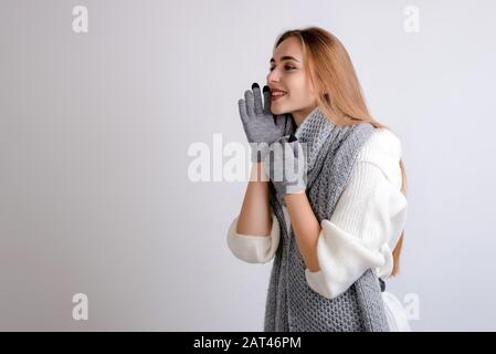 Happy beautiful woman calling someone on gray background copy space Stock Photo