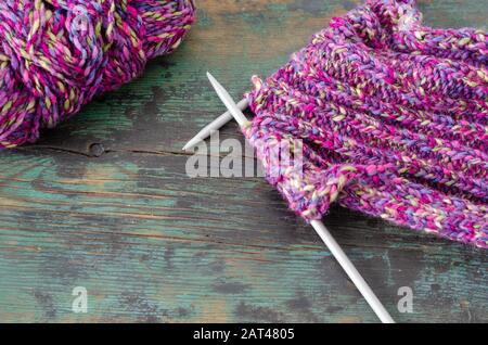High angle view of  knitting needles and yarn on wooden table Stock Photo