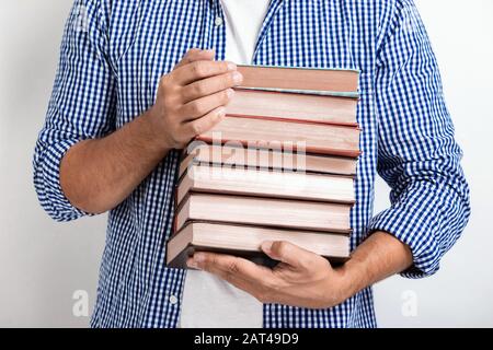 Closeup man holding books in his hands. Back to school.- Image Stock Photo