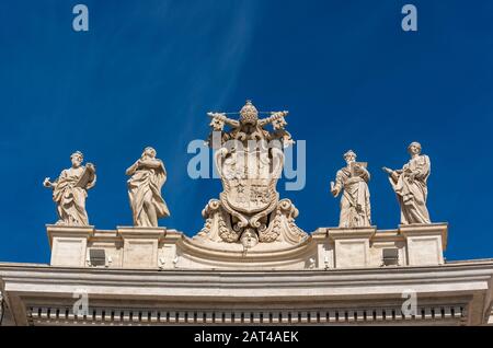 Alexander VII Coat of Arms and statues of saints Mark the Evangelist, Mary of Egypt, Ephraim and Theodosia above entrance to St. Peter's Square, Vatic Stock Photo