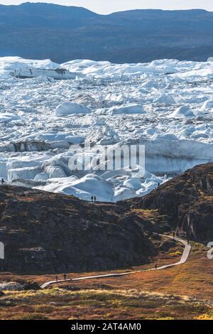 View towards Icefjord in Ilulissat. Easy hiking route to the famous Kangia glacier near Ilulissat in Greenland. The Ilulissat Icefjord seen from the Stock Photo