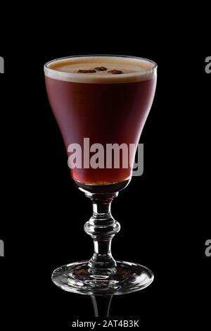 Glass of espresso martini isolated on black background Stock Photo