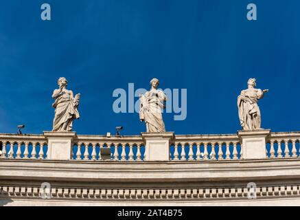 Statues of St Pontian, St. Columba and St Mamas on Bernini colonnades, St. Peter's Square, Vatican, Rome, Italy Stock Photo