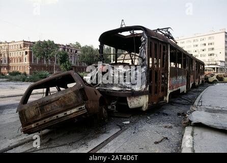 17th August 1993 During the Siege of Sarajevo: wrecked and burned-out trams and cars at the road junction of Hamze Hume with Hiseta Street and Obala Kulina bana, immediately north of Skenderija Bridge. Stock Photo
