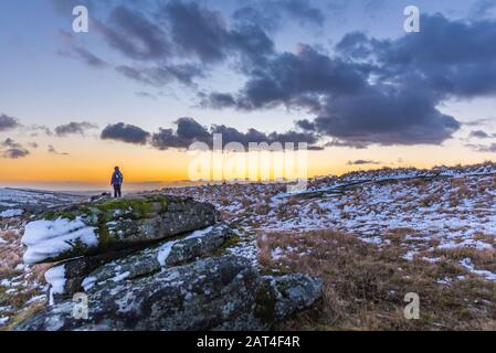 Nattor down in the snow at sunset, lone female hiker Stock Photo