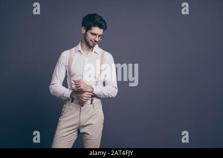 Portrait of his he nice attractive professional imposing elegant luxurious brunette man fixing button preparing to leadership event isolated on grey Stock Photo