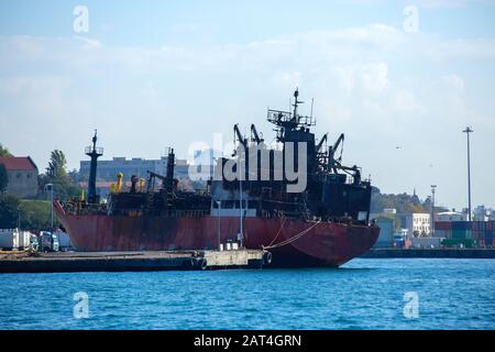 Rusty old abandoned oil tanker wreck pulled to harbor in Haydarpasa Port, Istanbul Turkey. Stock Photo