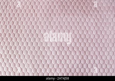 Pink color hexagon mesh fabric textured background. Stock Photo
