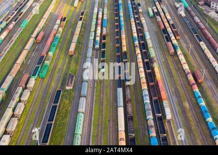 Aerial perspective view of railroad tracks, cargo sorting station. Many different railway cars with cargo and raw materials Stock Photo