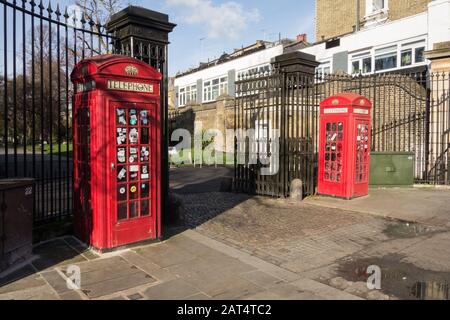 Red K6 telephone boxes by Sir Giles Gilbert Scot adorning the entrance to Brompton Cemetery, Fulham Road, Chelsea, London, SW10, UK Stock Photo