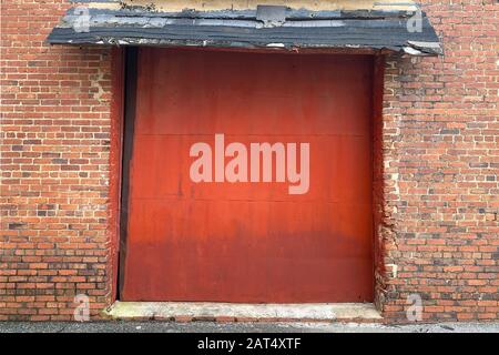 detailed red bay doors alley way old brick wall building barn farm Stock Photo