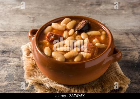 Typical Spanish fabada asturiana on wooden table Stock Photo