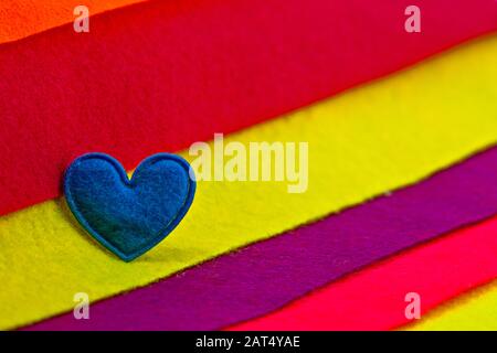 Blue heart on multicolored felt background Stock Photo