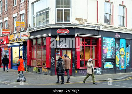 Colourful shop fronts and street art in Brick Lane Whitechapel London England UK Stock Photo
