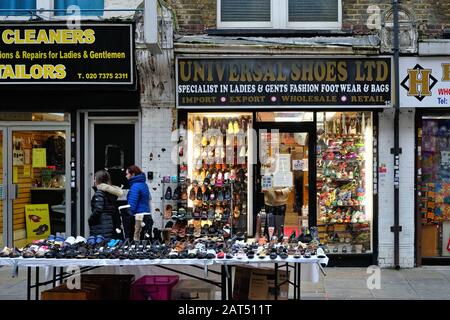 The front window display of an old style shoe shop on Wentworth Street Whitechapel East London England UK Stock Photo