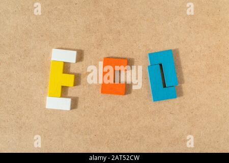 Word ECO made from colorful wooden bricks on kraft cardboard background. Top view, flat lay. Stock Photo