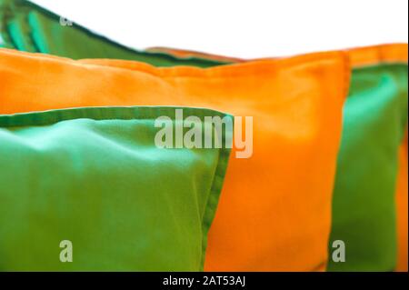 Row of colorful pillows, isolated on white, shallow DOF Stock Photo