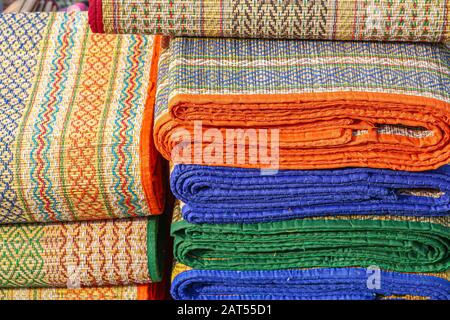 Handmade jute carpets kept in a pile for sale at a handicraft exhibition at Kolkata Stock Photo