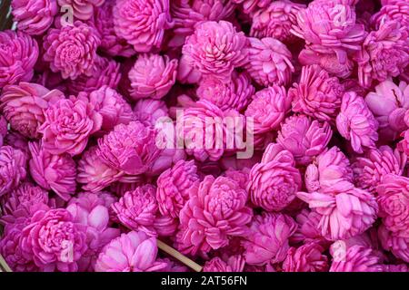 Beautiful handmade flowers made of fabric paper used for home decoration on display at a handicraft fare at Kolkata. Colorful flowers background Stock Photo