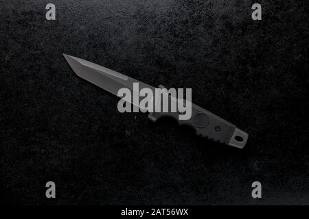 Closeup shot of a fixed sharp knife on a black background Stock Photo