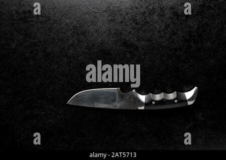 Closeup shot of a fixed sharp knife on a black background Stock Photo