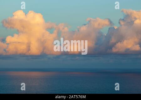 clouds over atlantic ocean catching early morning sun Stock Photo